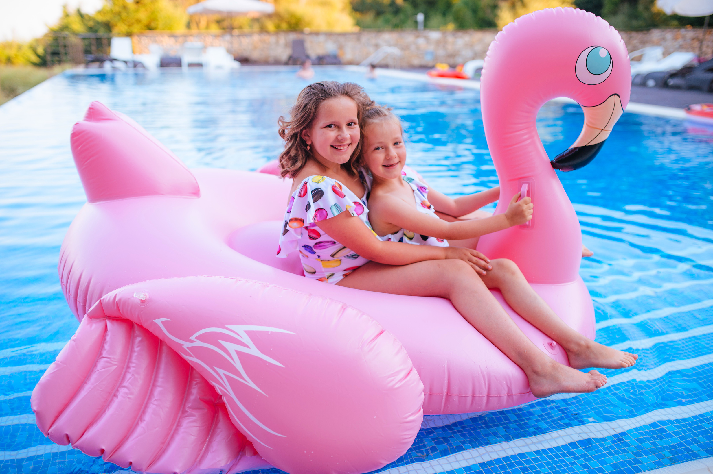 two people on large flamingo float